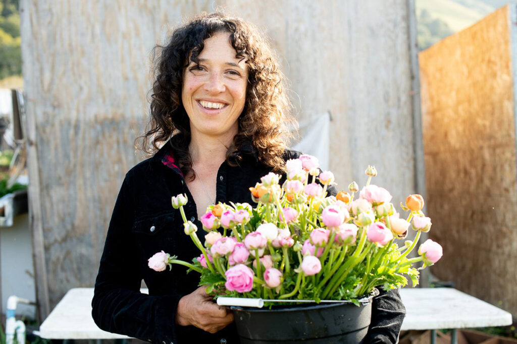 Molly Myerson of Little Wing Farm posing with cut flowers - MALT