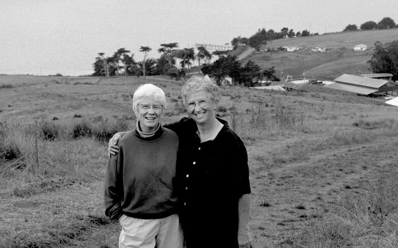 Ellen Straus and Phyllis Faber, founders of MALT, standing about the Straus Home Ranch and Tomales Bay. 