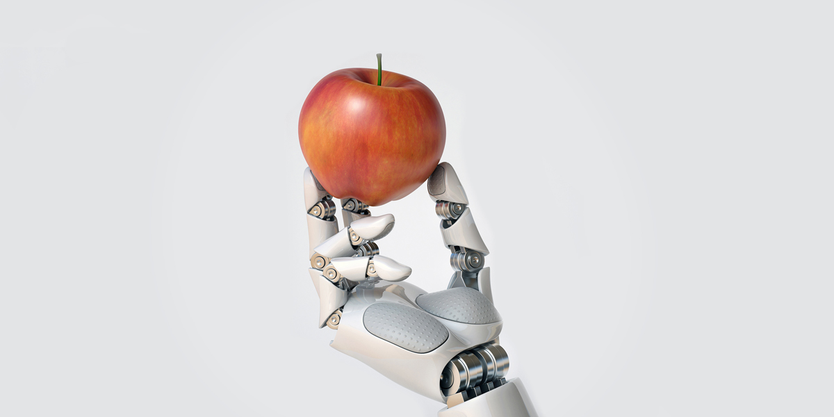 Robotic hand holding and apple.