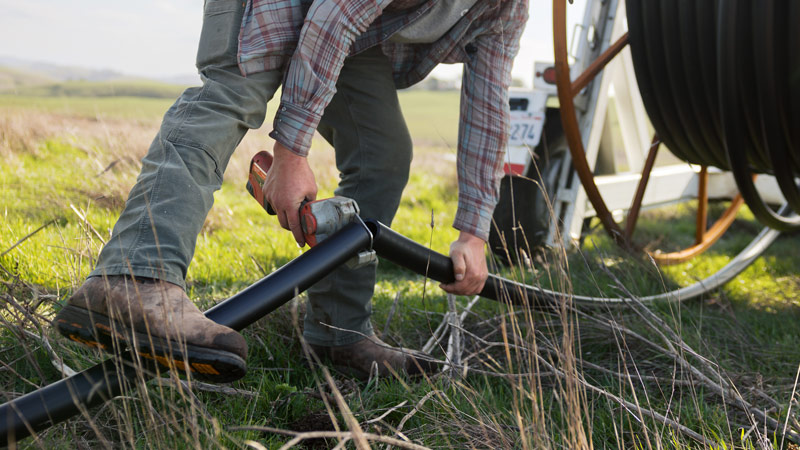 Local rancher assembles pipe as part of new climate-smart agriculture project funded by MALT